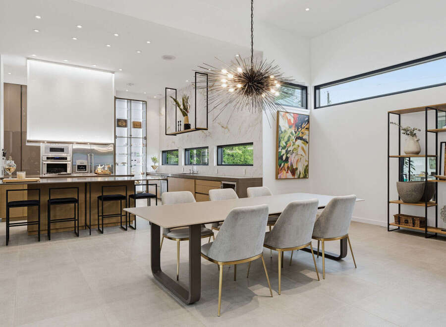 Experience modern luxury in this stunning open-concept living space, featuring a gourmet kitchen with state-of-the-art appliances and a spacious island perfect for entertaining.