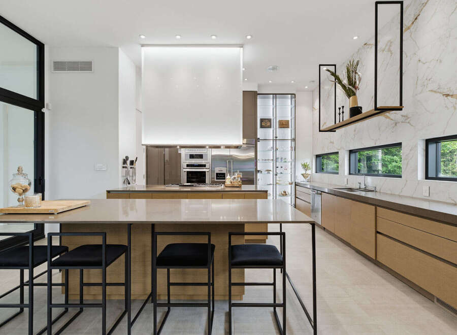 Experience luxury in this modern kitchen featuring a spacious island with bar seating, perfect for entertaining.