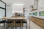 Experience luxury in this modern kitchen featuring a spacious island with bar seating, perfect for entertaining.