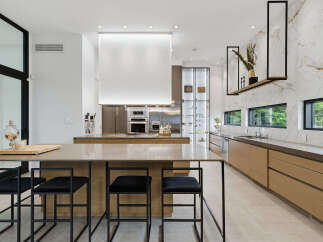 Experience luxury in this modern kitchen featuring a spacious island with bar seating, perfect for entertaining.