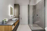 Experience modern luxury in this stunning bathroom featuring a sleek vanity with a vessel sink and integrated lighting.