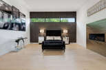 Experience modern luxury in this master bedroom featuring a striking tufted headboard and plush seating.