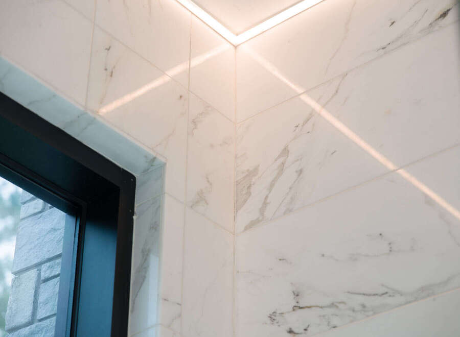 Experience modern luxury with these stunning marble-look tiles, perfectly complemented by sleek, integrated LED lighting.
