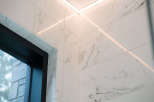 Experience modern luxury with these stunning marble-look tiles, perfectly complemented by sleek, integrated LED lighting.