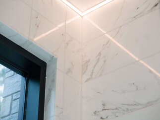 Experience modern luxury with these stunning marble-look tiles, perfectly complemented by sleek, integrated LED lighting.