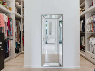 Step into this luxurious walk-in closet, featuring ample storage with custom shelving and hanging space for your extensive wardrobe.