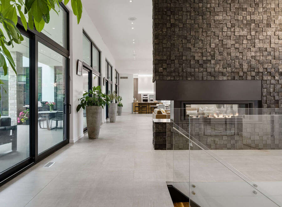 Experience modern luxury in this stunning home featuring a dramatic stone-clad fireplace as the centerpiece of the living space.