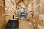 Discover this exquisite wine cellar, featuring a unique cork-lined ambiance that enhances the tasting experience.