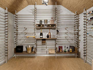 Discover this exquisite wine cellar, featuring a sophisticated racking system designed to elegantly display your collection.