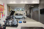 Experience the ultimate in home fitness with this state-of-the-art gym, complete with an elliptical and punching bag.