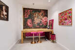 This stylish room features a striking leopard and floral tapestry as a backdrop to a modern wooden desk.