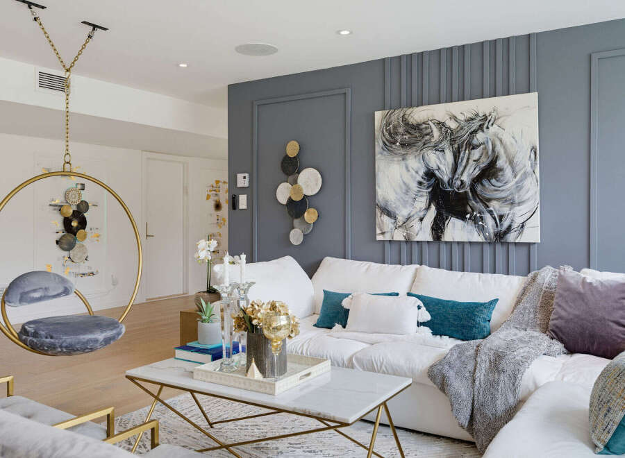 Experience modern luxury in this stunning living room, featuring a unique hanging chair and a captivating abstract horse painting.