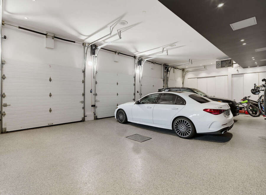 This spacious garage features multiple overhead doors, providing ample space for vehicles and storage.