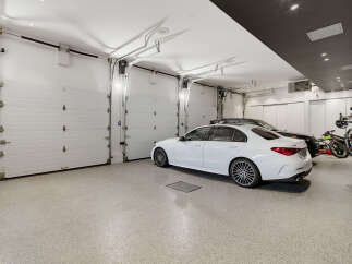 This spacious garage features multiple overhead doors, providing ample space for vehicles and storage.