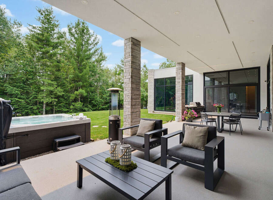 Experience ultimate relaxation and entertainment in this luxurious outdoor living space, featuring a spacious hot tub perfect for unwinding.