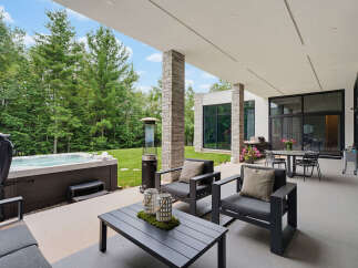Experience ultimate relaxation and entertainment in this luxurious outdoor living space, featuring a spacious hot tub perfect for unwinding.