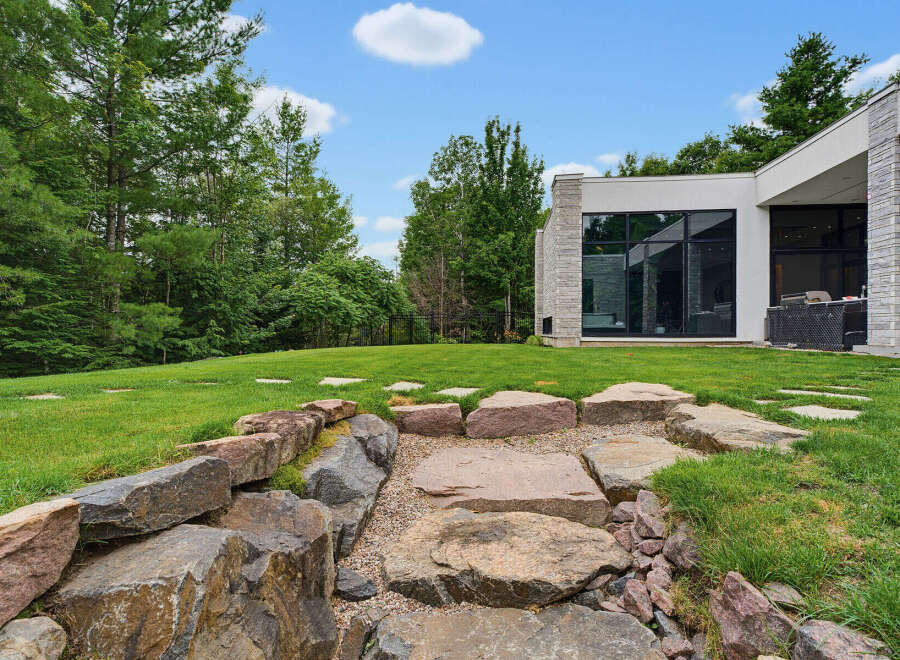 Experience modern luxury in this stunning home featuring a sleek architectural design and expansive windows that seamlessly blend indoor and outdoor living.
