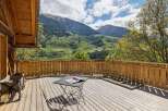 Enjoy breathtaking mountain views from this charming wooden deck, perfect for relaxing or entertaining.