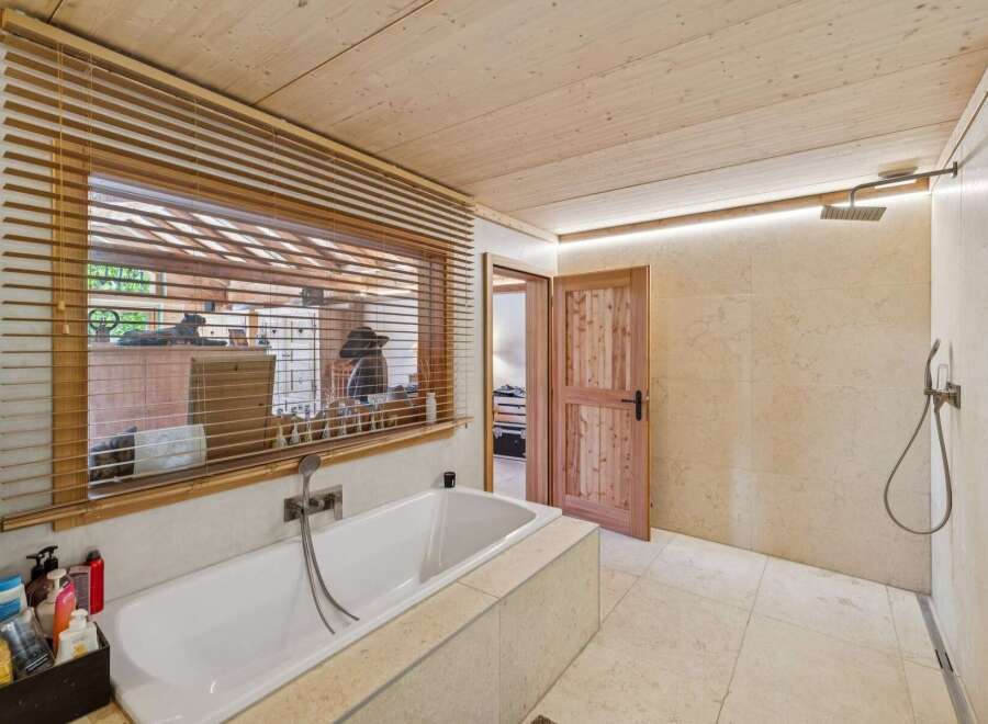 Experience ultimate relaxation in this luxurious bathroom featuring a deep soaking tub and a spacious walk-in shower.