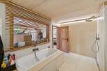 Experience ultimate relaxation in this luxurious bathroom featuring a deep soaking tub and a spacious walk-in shower.