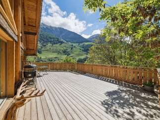 Enjoy breathtaking mountain views from this expansive wooden deck, perfect for outdoor entertaining.