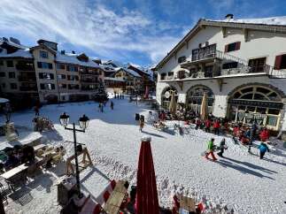 Experience the charm of a snowy alpine village with this picturesque scene.