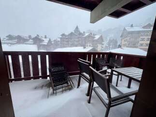 Experience the magic of a winter wonderland from your private balcony, complete with snow-covered furniture and breathtaking mountain views.