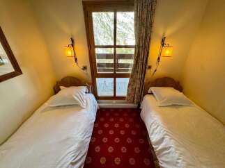 This charming bedroom features two twin beds, perfect for accommodating guests or family.