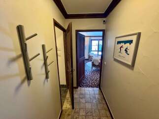 Step into this charming hallway, featuring unique tree-shaped coat racks perfect for outerwear.