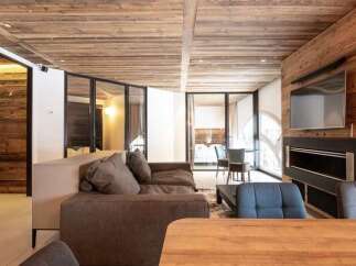Experience modern alpine living in this beautifully appointed living space, featuring a plush sectional sofa perfect for relaxation.