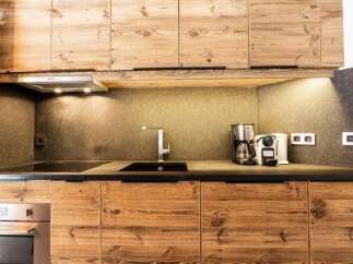 Experience modern living in this charming kitchen, featuring rustic wooden cabinetry that adds warmth and character.