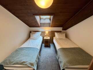 This charming room features two cozy twin beds, perfect for guests or a shared sleeping space.
