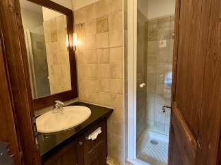 This charming bathroom features a spacious vanity with a modern sink and ample counter space, perfect for your morning routine.