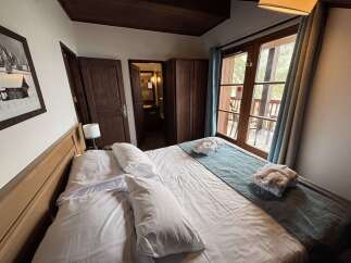 Experience ultimate comfort in this inviting hotel room, featuring a plush king-sized bed adorned with crisp white linens and an array of soft pillows.