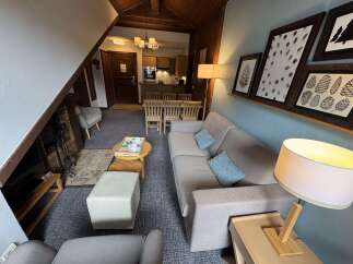 Experience cozy living in this charming apartment featuring a comfortable living area with a fireplace and a well-equipped kitchen.
