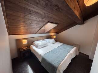 Experience cozy comfort in this charming hotel room featuring two twin beds, perfect for solo travelers or friends.