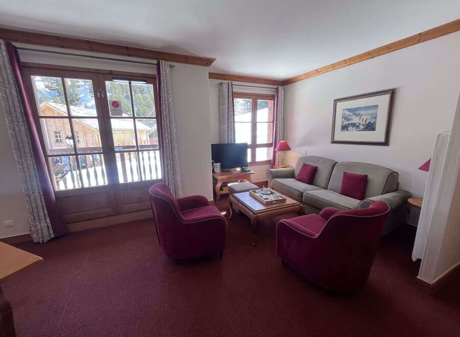 Experience cozy mountain living in this charming living room, featuring plush seating and a warm ambiance.