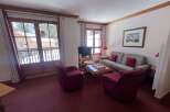 Experience cozy mountain living in this charming living room, featuring plush seating and a warm ambiance.