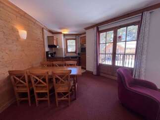 Experience cozy mountain living in this charming dining area, featuring a warm wooden table and chairs perfect for family meals.