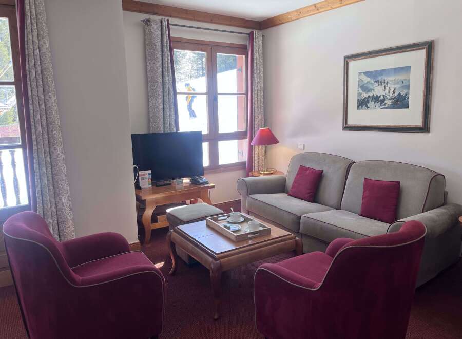 Experience ultimate comfort in this inviting living room, featuring plush seating and a cozy ambiance.