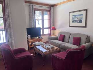Experience ultimate comfort in this inviting living room, featuring plush seating and a cozy ambiance.