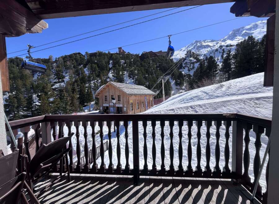 Experience breathtaking mountain views from this charming chalet, complete with a private balcony overlooking a ski resort.