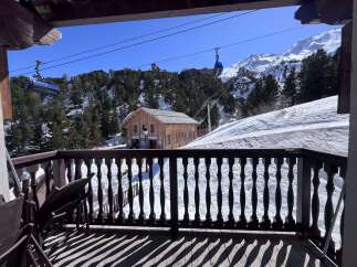 Experience breathtaking mountain views from this charming chalet, complete with a private balcony overlooking a ski resort.