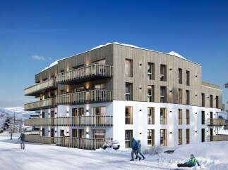 Experience luxury mountain living in this stunning modern apartment complex, perfectly situated in a snowy landscape.