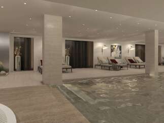 Indulge in relaxation at this luxurious indoor pool area, featuring comfortable lounge chairs and serene ambiance.