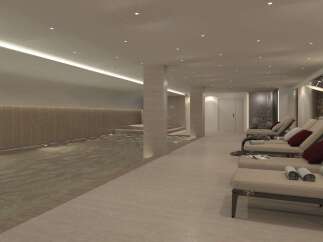 Indulge in relaxation at this luxurious indoor pool area, featuring a serene swimming pool with ambient lighting and comfortable lounge chairs.