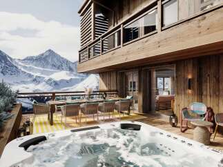 Experience luxury mountain living with this stunning property featuring a private hot tub and an expansive outdoor dining area, perfect for entertaining.