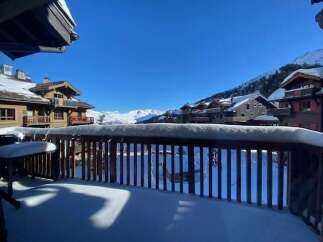 Experience breathtaking mountain views from this charming ski chalet balcony, perfect for enjoying your morning coffee or evening après-ski.