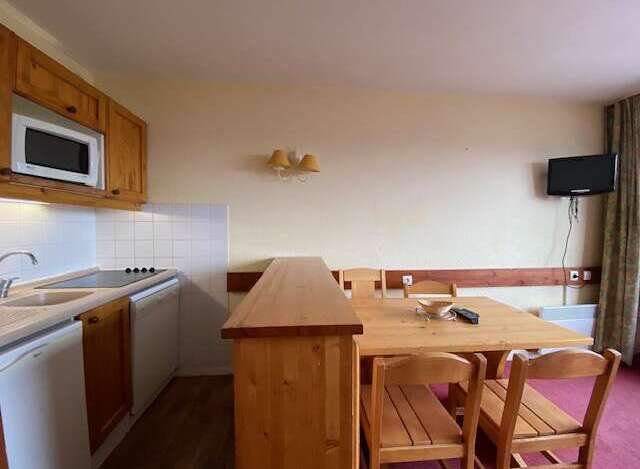 This charming studio apartment features a well-equipped kitchenette with a microwave and stovetop, perfect for preparing meals.