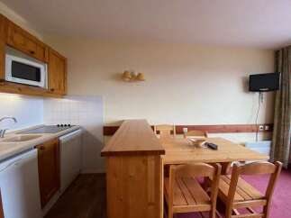 This charming studio apartment features a well-equipped kitchenette with a microwave and stovetop, perfect for preparing meals.